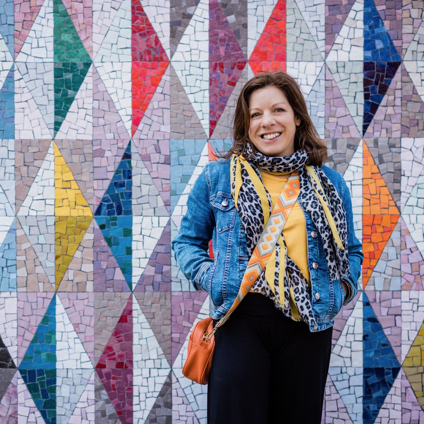 Ads strategist Rachel Fallon standing in front of a colourful wall in Shoreditch